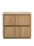Front view of an oak nightstand with two vertically reeded drawers, slim metal pulls and a gold-toned base.