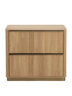 Front view of an oak nightstand with two vertically reeded drawers, slim metal pulls and a gold-toned base.