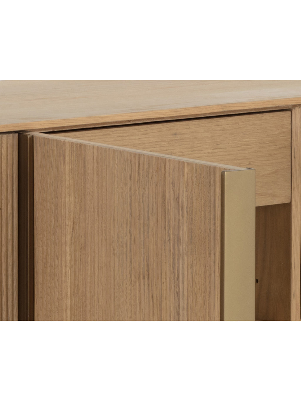 Close-up of an open sideboard door with visible oak grain and a gold-coloured edge, with an interior drawer behind it.