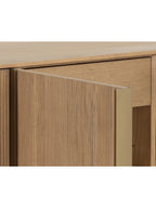 Close-up of an open sideboard door with visible oak grain and a gold-coloured edge, with an interior drawer behind it.