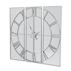 Angled view of the Reflected Dial Wall Clock, with a silver-toned Roman-numeral dial spanning three tall mirrored panels.