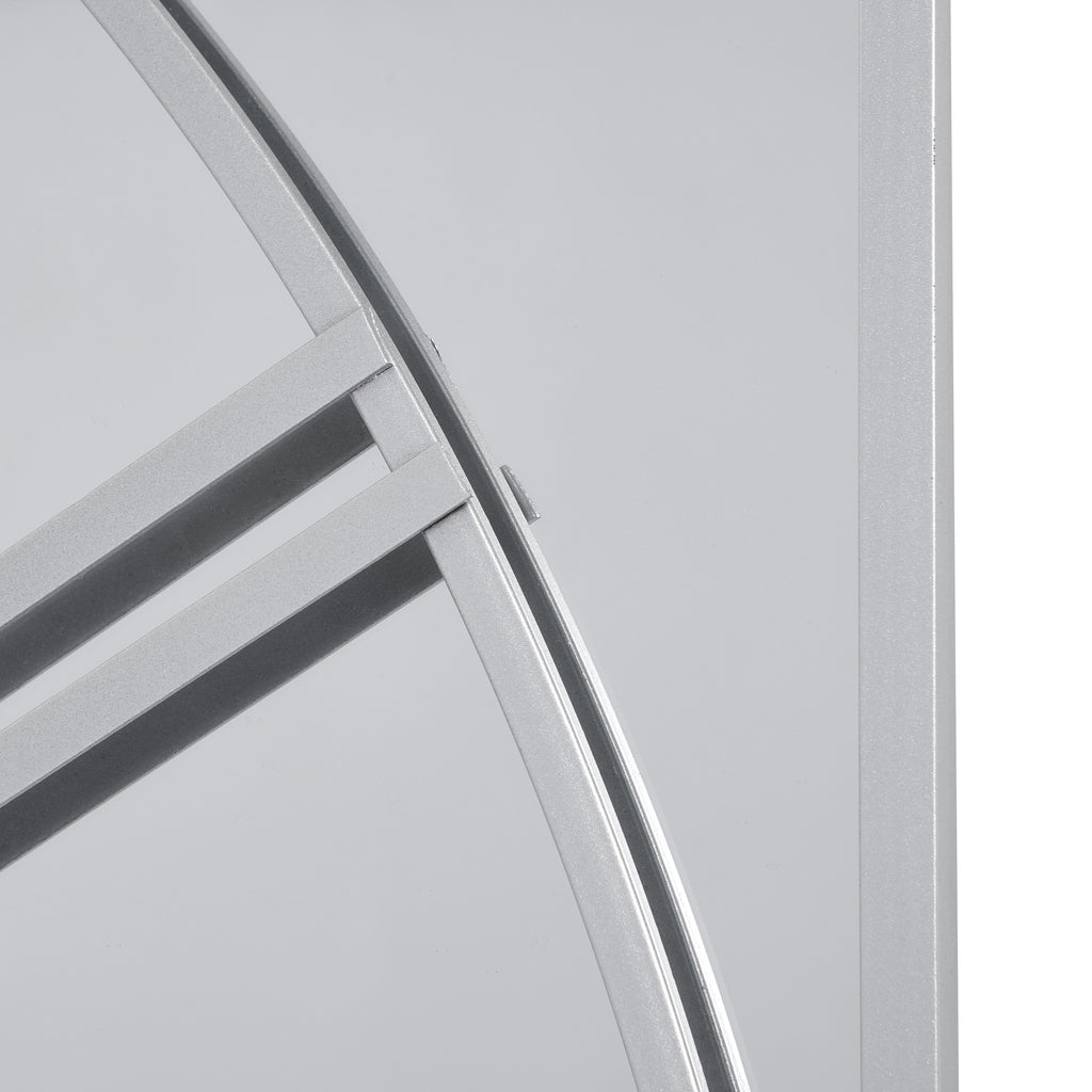 Detail of the silver-toned dial curve and numeral bars against the mirror, beside a straight rectangular panel border.