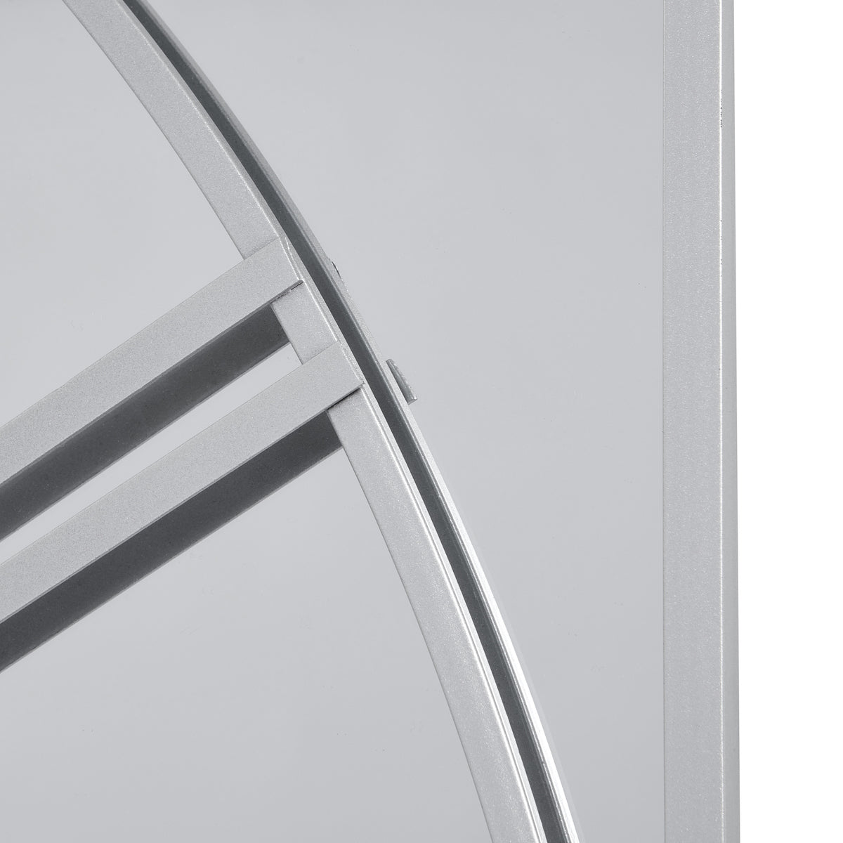 Detail of the silver-toned dial curve and numeral bars against the mirror, beside a straight rectangular panel border.