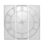 Front view of the mirrored wall clock showing its open circular dial, separated rectangular panels and ornate central hands.