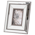 Angled view of a portrait photo frame with stepped reflective panels, dark brown edging and a pine-cone picture insert against a white background.
