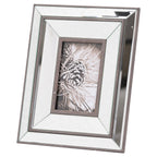 Angled view of a portrait photo frame with stepped reflective panels, dark brown edging and a pine-cone picture insert against a white background.
