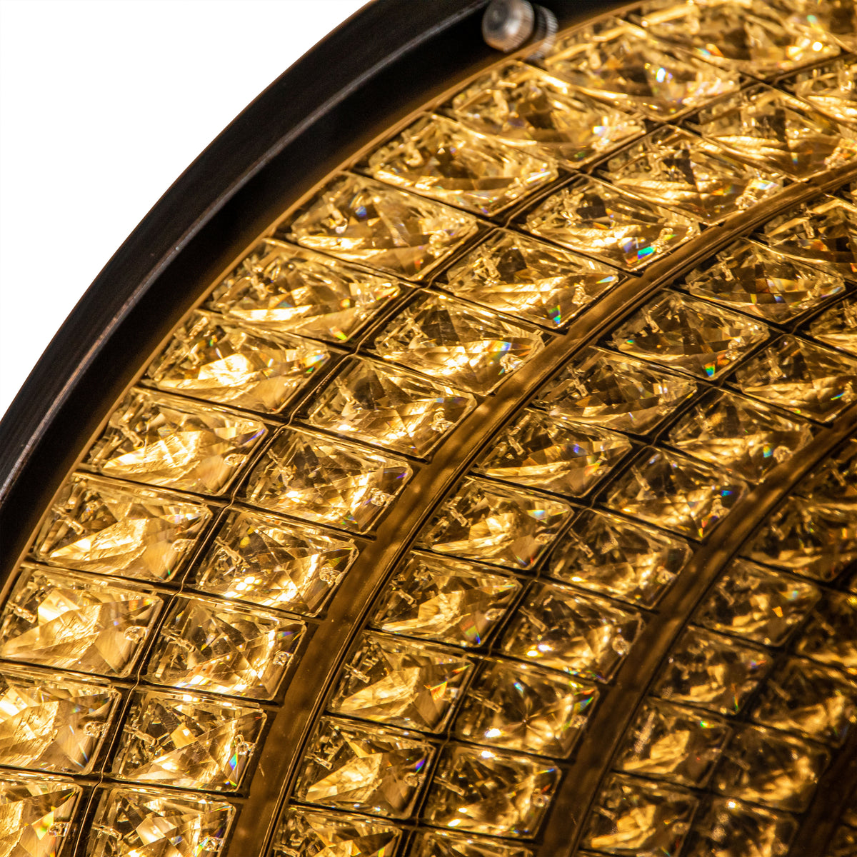 Detail of the illuminated mirror face, with repeated rows of bright golden faceted shapes.