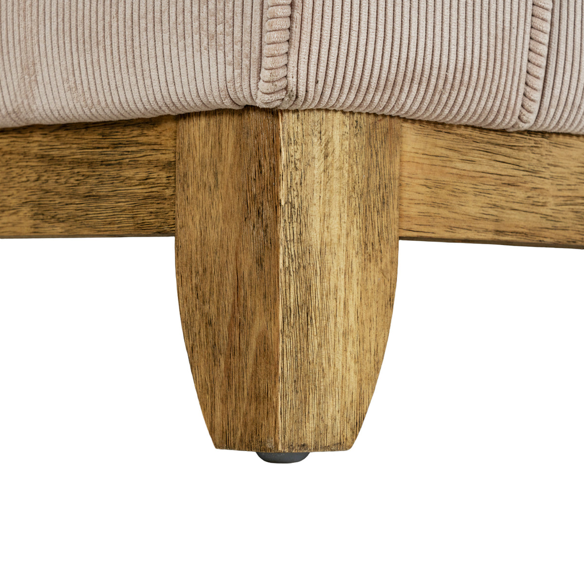 Close-up of a brown sofa foot and adjoining lower rails beneath the cream ribbed upholstery.
