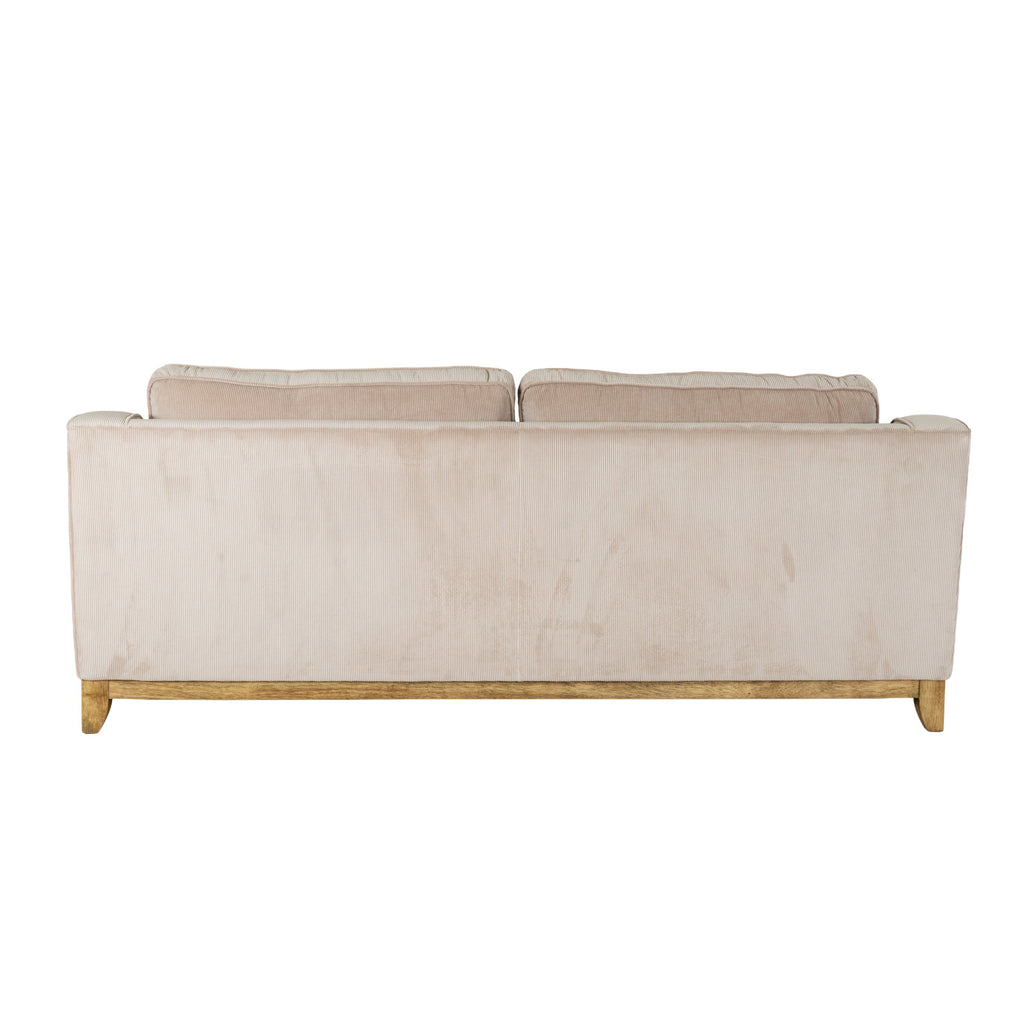 Rear view of the sofa with a broad cream ribbed back panel and the tops of two back cushions visible above it.