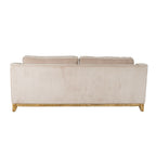 Rear view of the sofa with a broad cream ribbed back panel and the tops of two back cushions visible above it.