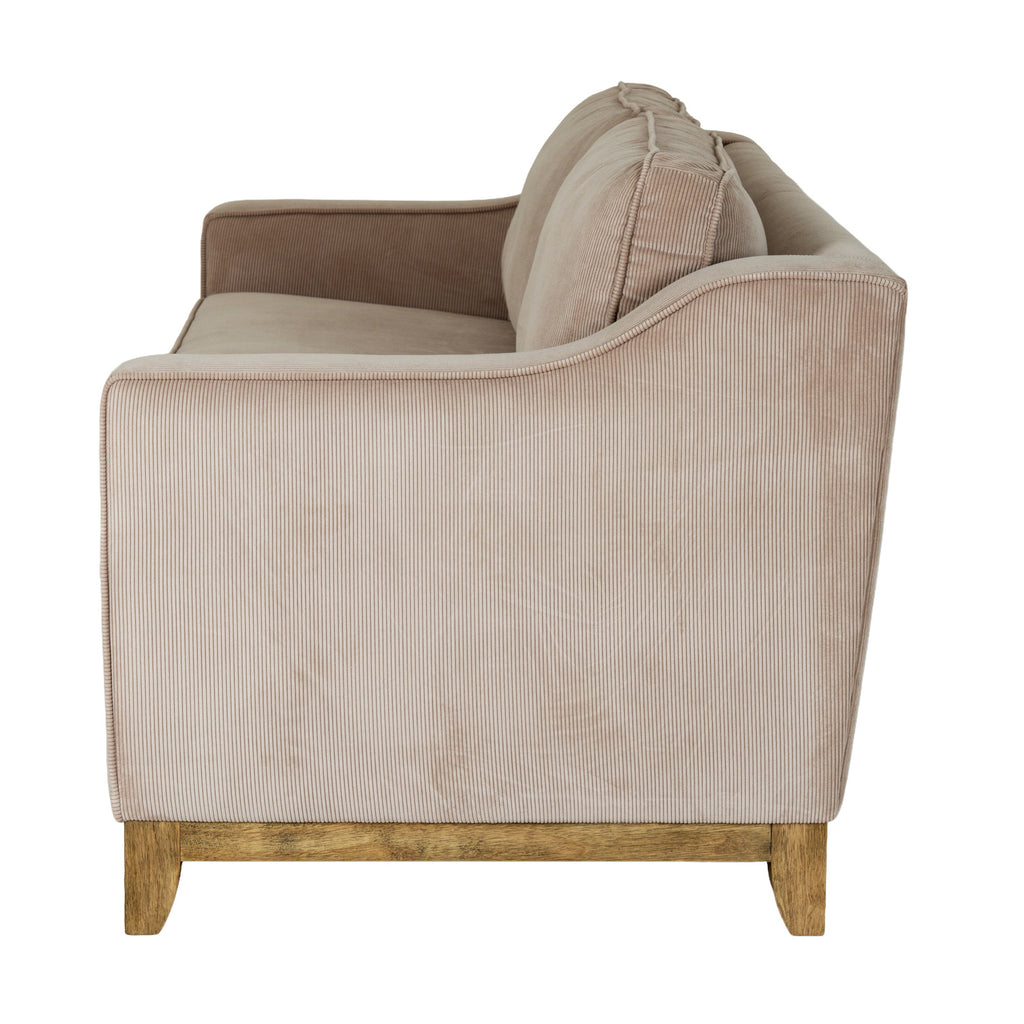 Side view of the sofa showing the upholstered arm rising towards the back above a brown lower rail and feet.