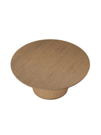 Dining table viewed from above at an angle, showing the circular wooden top and its grain with the ribbed pedestal visible below.