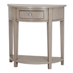 Front view of the pale grey-beige half-moon console table, showing its curved drawer, silver-coloured knob, four square legs and low shelf.
