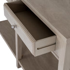 Close angled view of an open console drawer showing its empty interior, ribbed silver-coloured knob and a long groove along the drawer side.