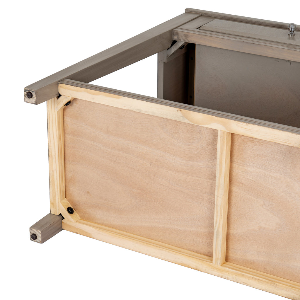 Underside view of the console showing lighter wood-toned panel framing, a central brace, diagonal corner blocks, black fastener recesses and dark round pads at the leg ends.