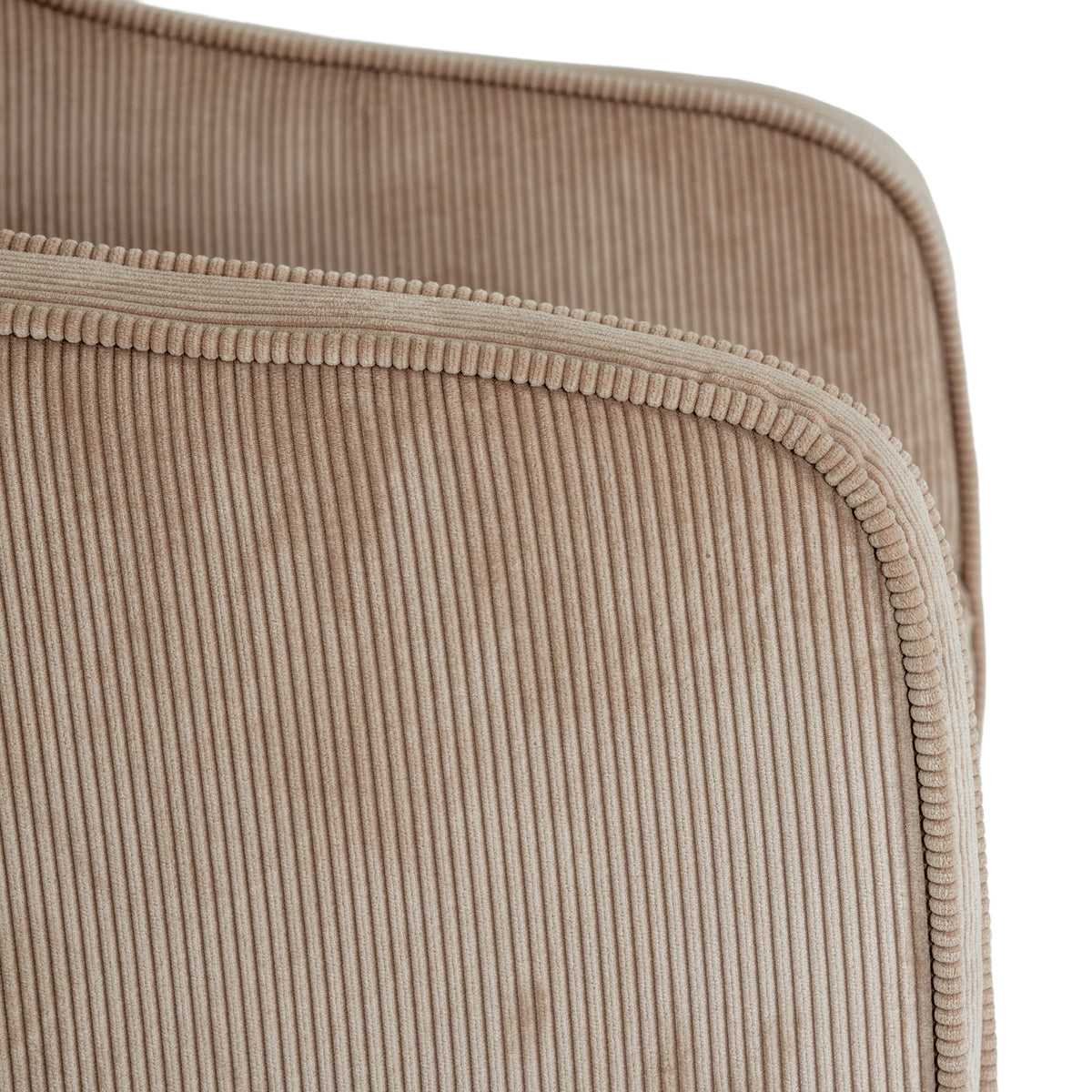 Close-up of the cream/taupe ribbed upholstery and matching raised edging along the curved arm, with the opposite arm behind.