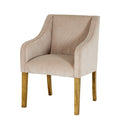 Front three-quarter view of the cream/taupe ribbed dining chair, showing its tall back, sweeping arms and four warm brown grained legs.