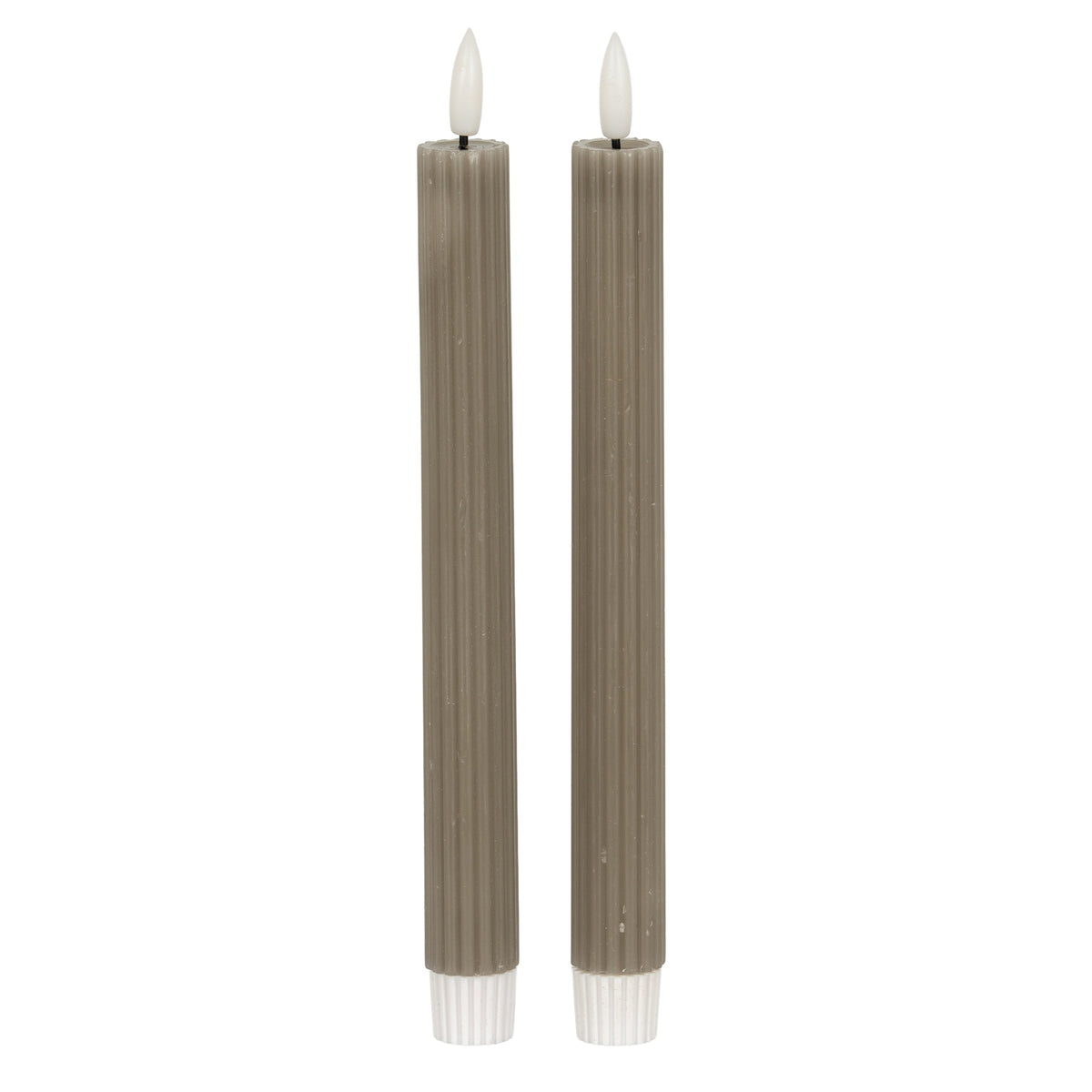Two unlit grey-taupe ribbed candles with white flame-shaped tips and white ribbed lower fittings against a white background.