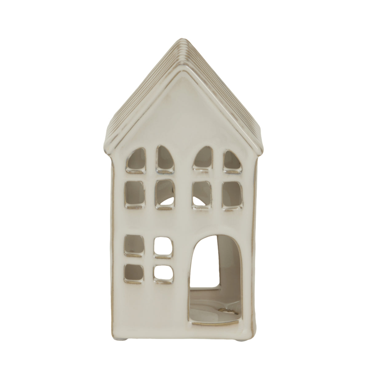 Front view of a cream-white house-shaped candle holder with a steep pitched roof, rows of window cut-outs and a large arched doorway.