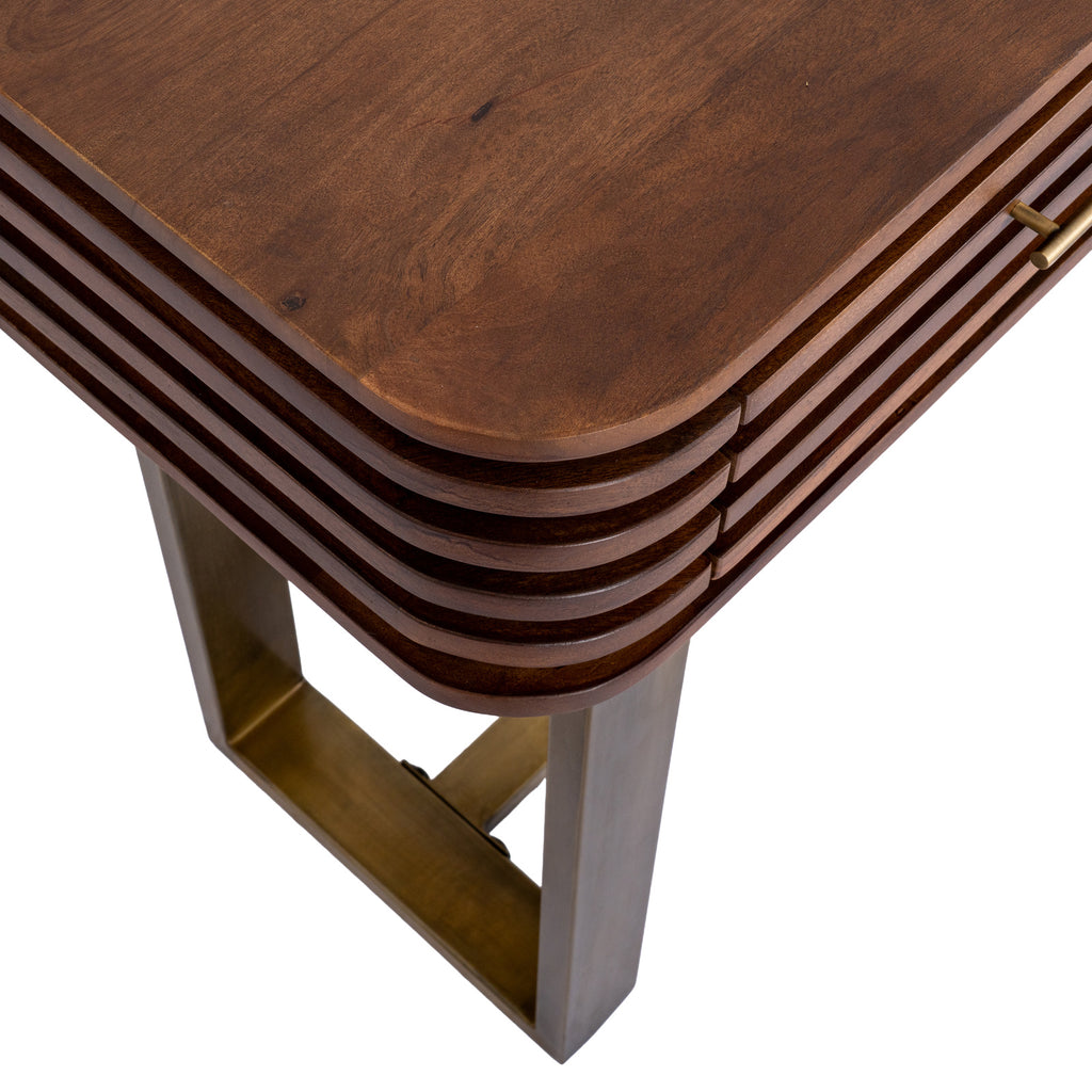 Close-up of the console's rounded top corner, horizontal ridges curving around the side and a gold-tone loop support below.