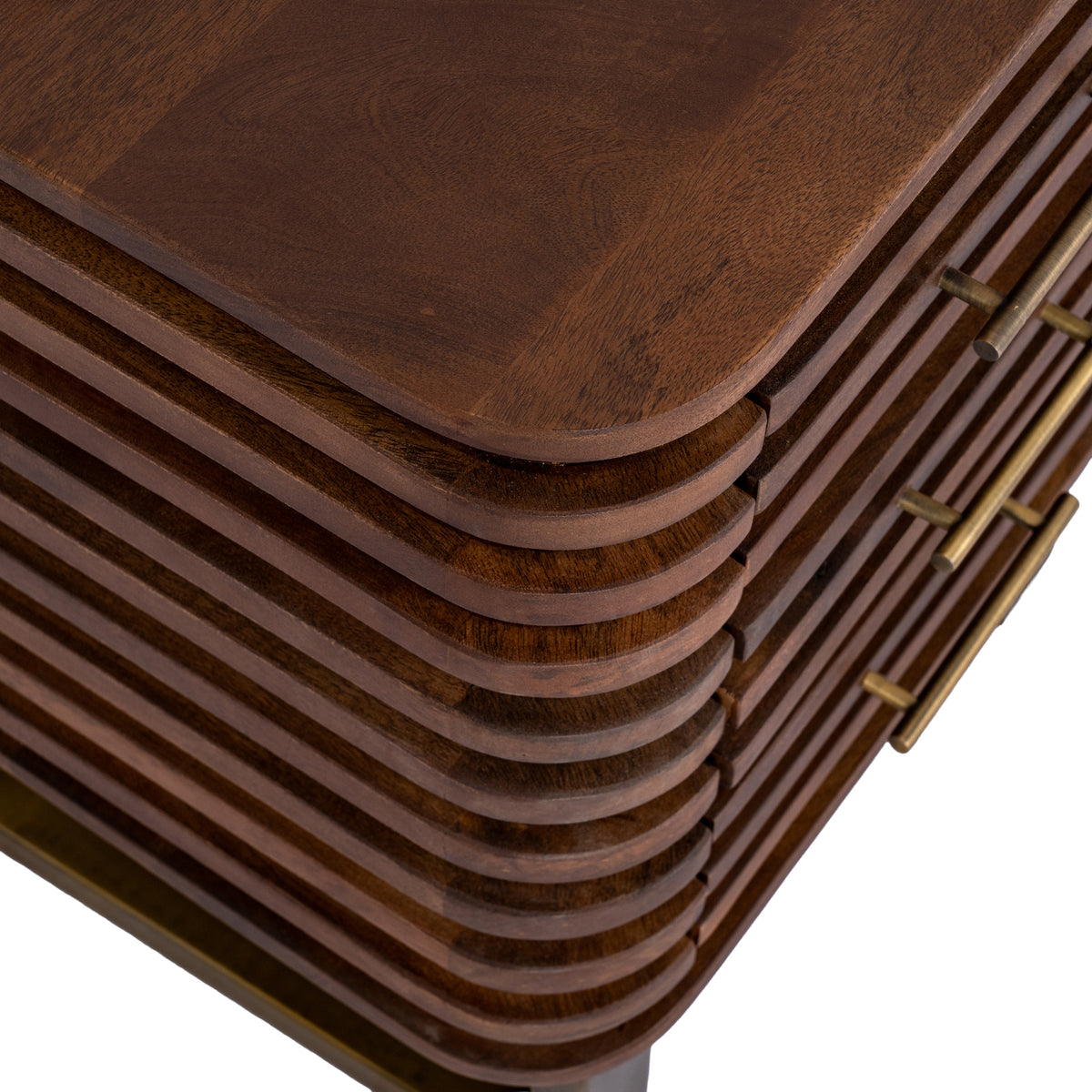 Overhead detail of the brown tabletop and rounded front corner, showing visible grain, horizontal ridges and gold-toned handles along the front.