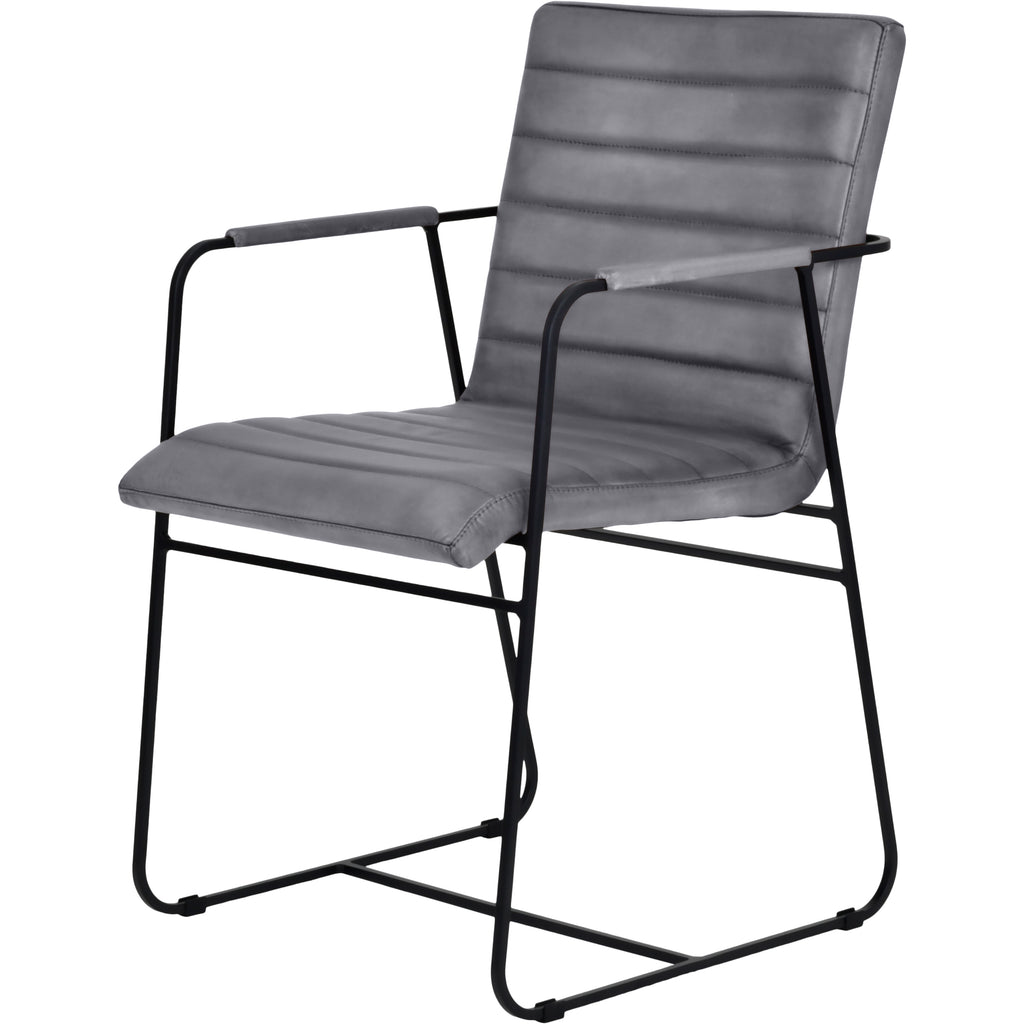 Three-quarter view of the grey leather dining armchair showing its stitched seat and back, open sides and curved black metal base.