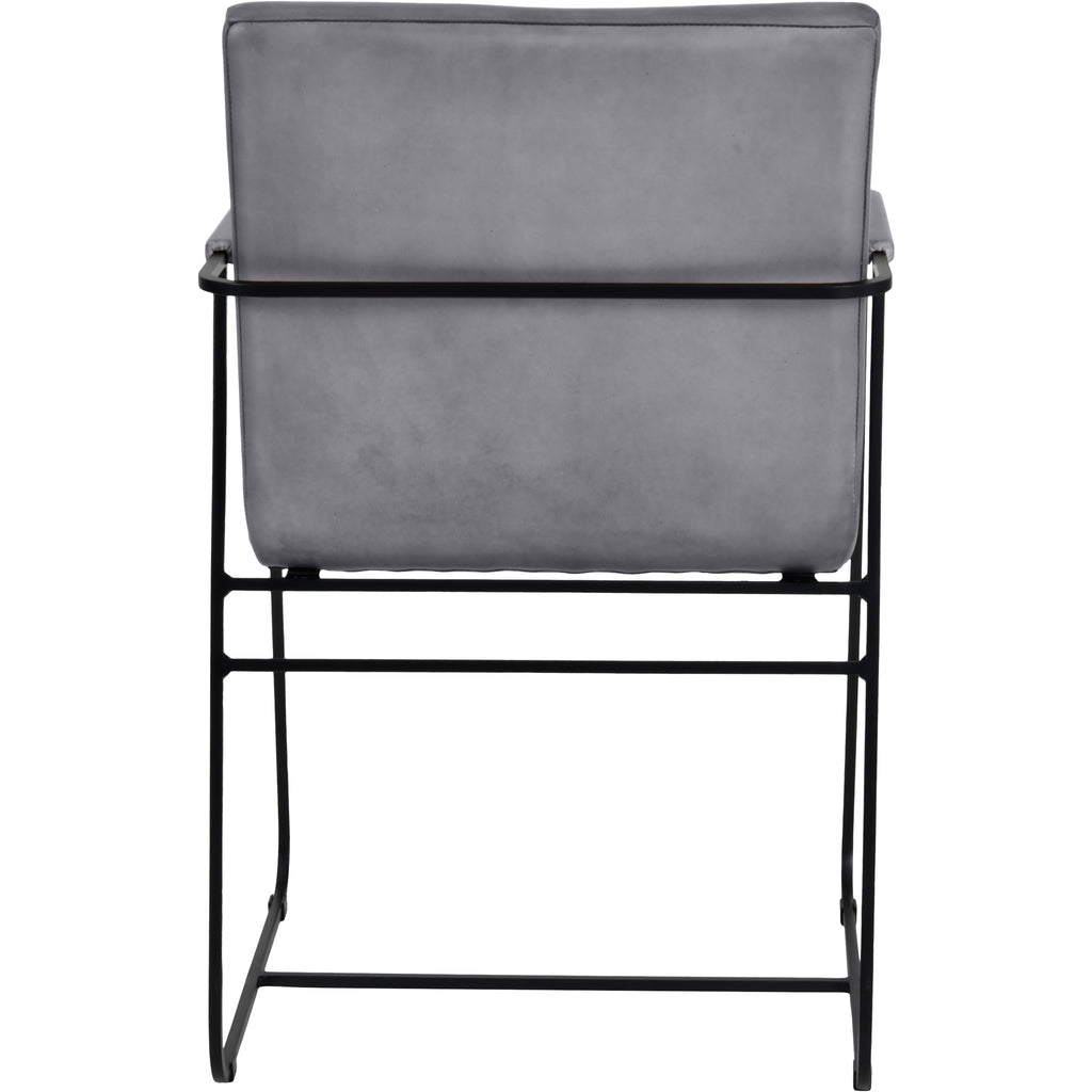 Rear view of the dining armchair with a plain grey upholstered back and a black metal rail running behind it.