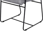 Detail of the dining chair's black metal base showing curved side rails, a connecting crossbar and the grey seat edge above.