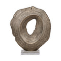 Front view of an antique gold ridged sculpture with an irregular oval opening on a pale rectangular marble base.