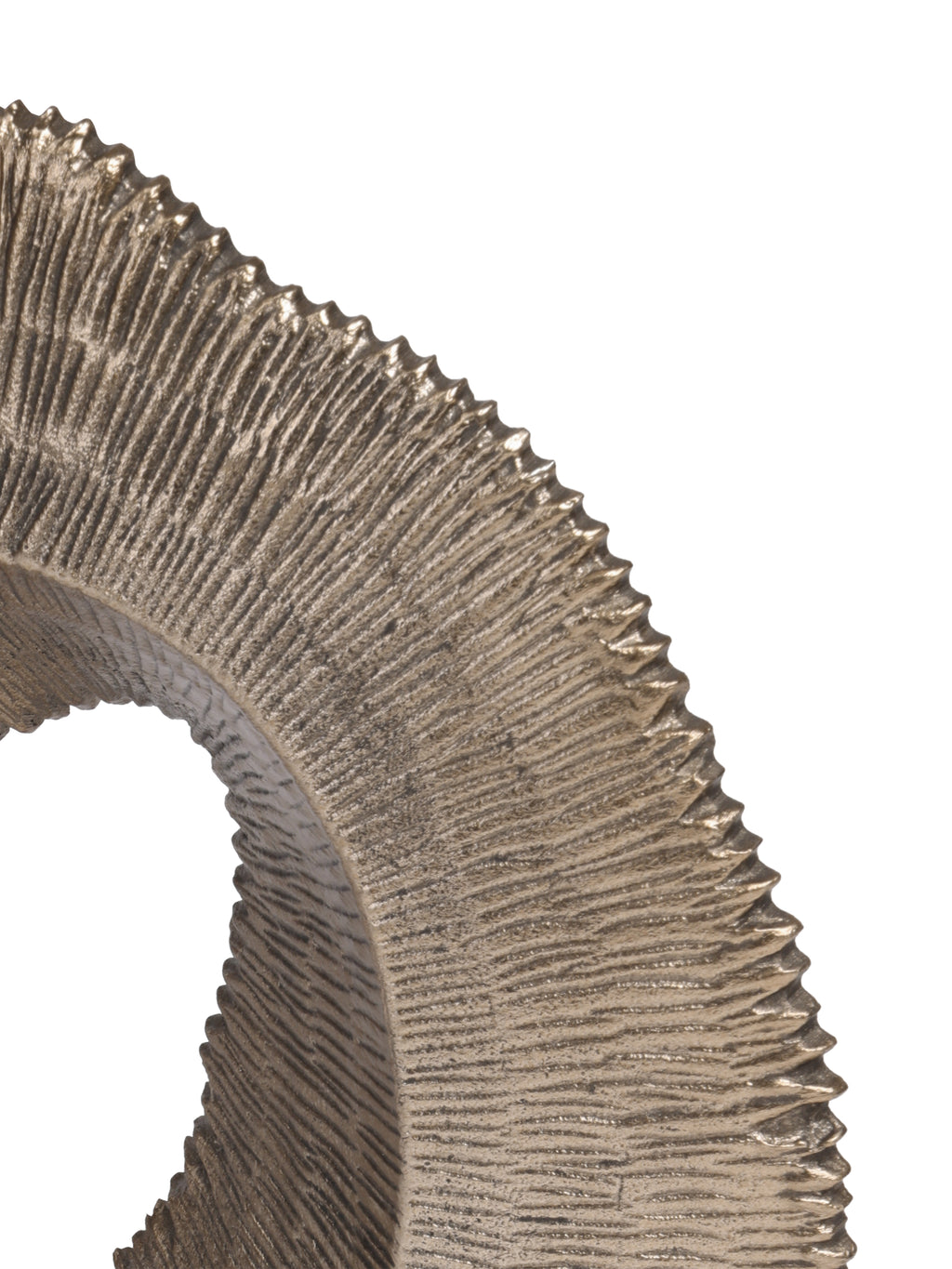 Close-up of deep radiating ridges and the rippled outer edge of the antique gold sculpture.