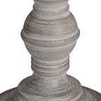 Close-up of the rounded lower lamp base, showing concentric ridges and uneven pale streaks across the grey-brown surface.