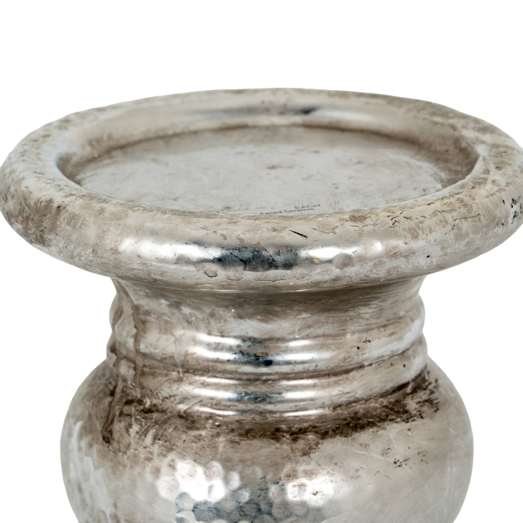 Close-up of the candle holder's recessed platform and rolled rim above the ringed neck, showing mottled silver-coloured detailing.