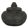 Charcoal-black squat decorative pot with its lid in place, showing a rounded ringed finial, raised shoulder band and mottled surface.
