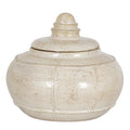 Cream decorative pot with its lid in place, showing a rounded body, raised bands and a domed ringed finial against white.