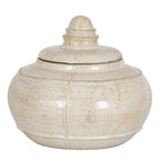 Cream decorative pot with its lid in place, showing a rounded body, raised bands and a domed ringed finial against white.