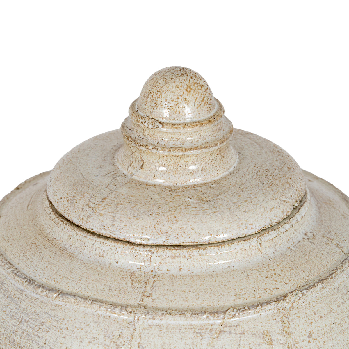 Close-up of the pot's stepped lid and domed finial, showing concentric rings, glossy highlights and irregular brown markings.