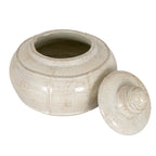 Elevated view of the open cream pot with its lid leaning to the right, showing the interior and beige-brown speckling.