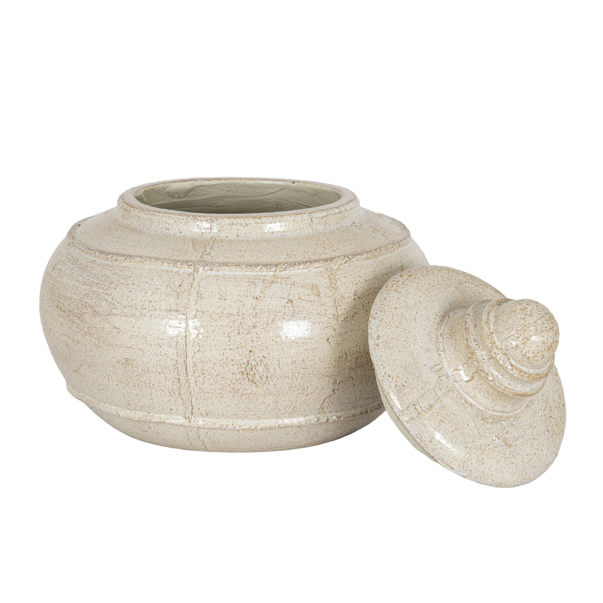 Open cream decorative pot viewed from the front with its lid resting at the right, showing the shoulder band, lower band and low foot ring.