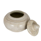 Elevated view of the open cream pot with its lid resting to the right, showing the circular opening and shaded interior.