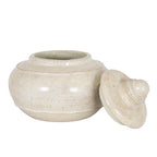 Open decorative pot viewed from the front, with its cream speckled lid leaning beside the rounded body on the right.