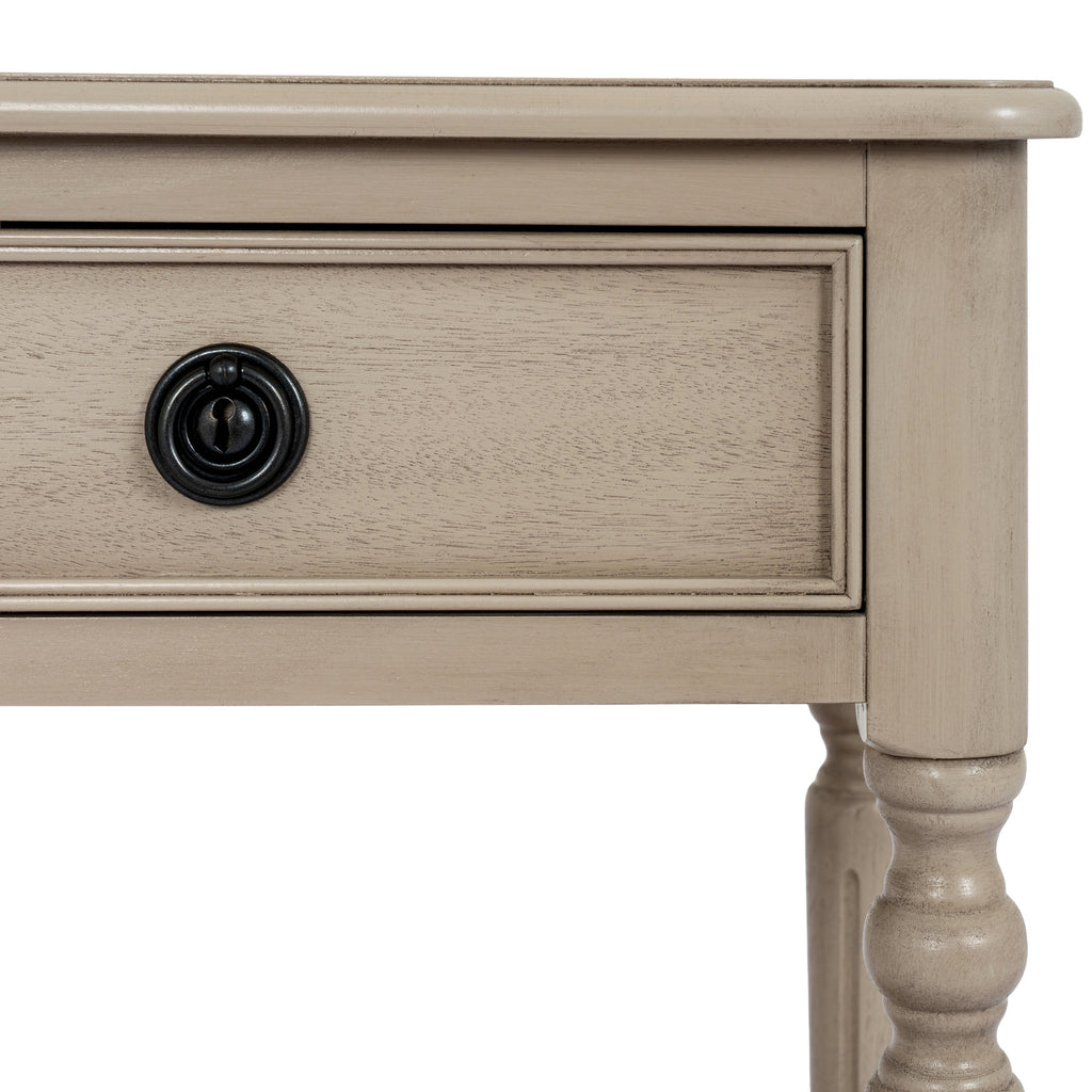 Close-up of the framed drawer front, black circular ring pull and rounded leg profile on the Ringline Side Table.