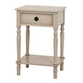 Ringline Side Table viewed from the front at an angle, showing its pale finish, framed drawer, black ring pull and lower shelf.