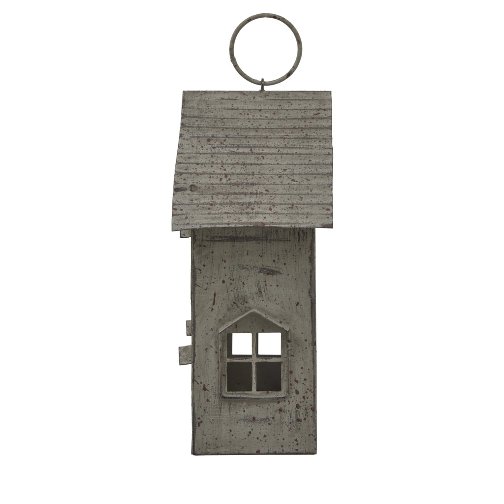 Side view of the house candle holder with a single four-pane window opening beneath the ridged roof and circular top ring.
