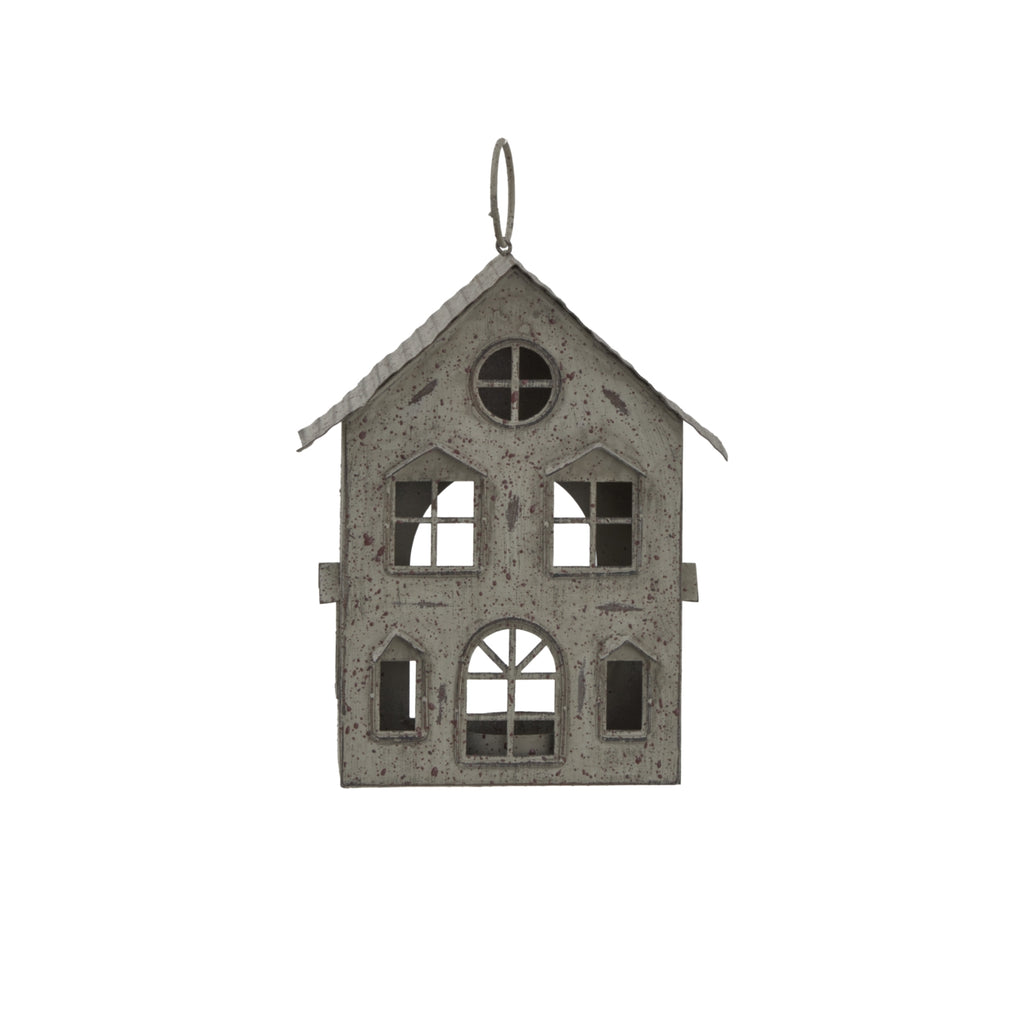 Front view of the pale-grey house candle holder with pierced windows, an arched doorway and a ring above the pitched roof.