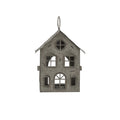 Front view of the pale-grey house candle holder with pierced windows, an arched doorway and a ring above the pitched roof.
