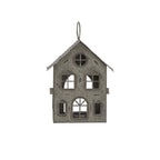 Front view of the pale-grey house candle holder with pierced windows, an arched doorway and a ring above the pitched roof.