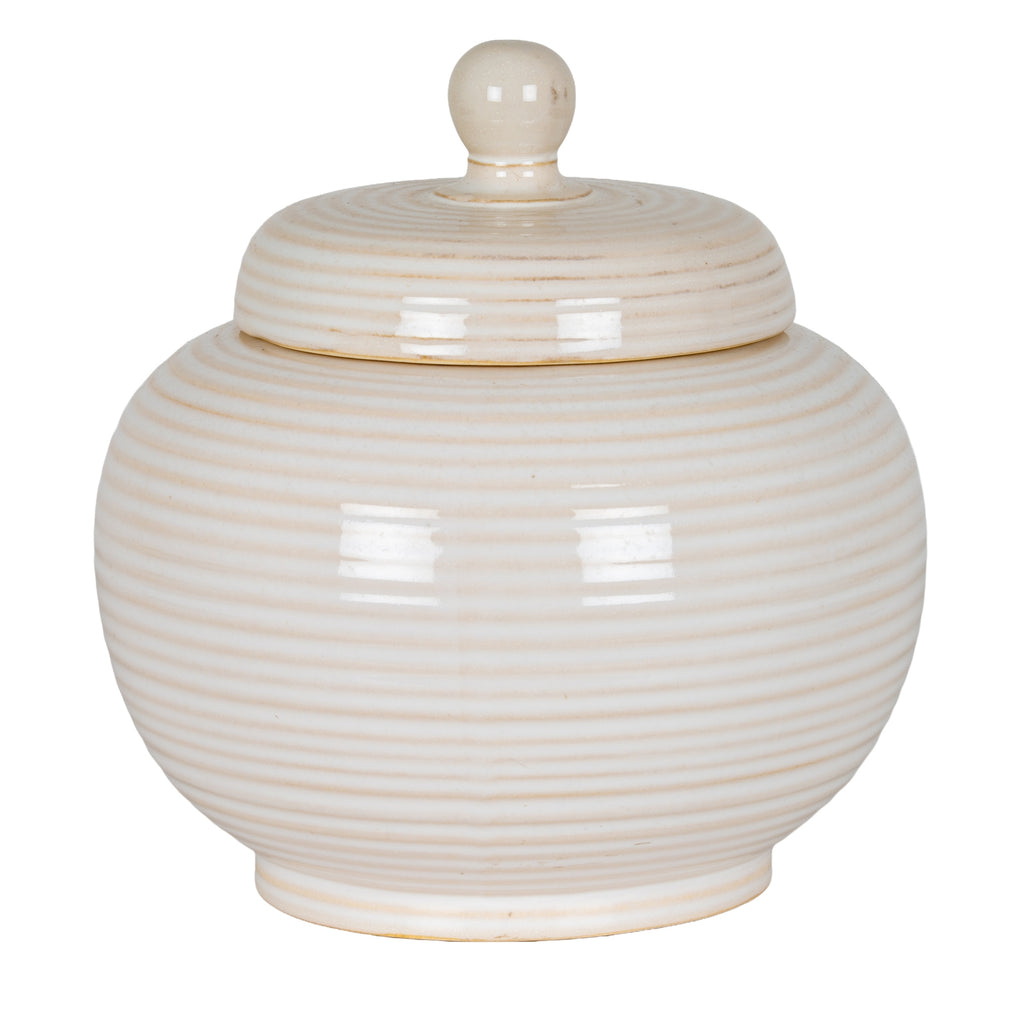 Cream-white ribbed jar with its domed lid in place, rounded knob and narrow raised foot against a white background.