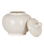 Ribbed jar with its circular mouth exposed and the concentric-ring lid leaning alongside, knob facing forwards.