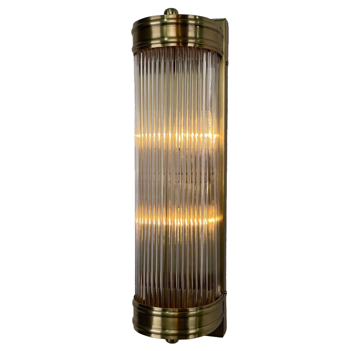 Illuminated Rod Shade Wall Light at a slight angle, with vertical glass rods, antique-brass-finished end bands and a rectangular backplate.