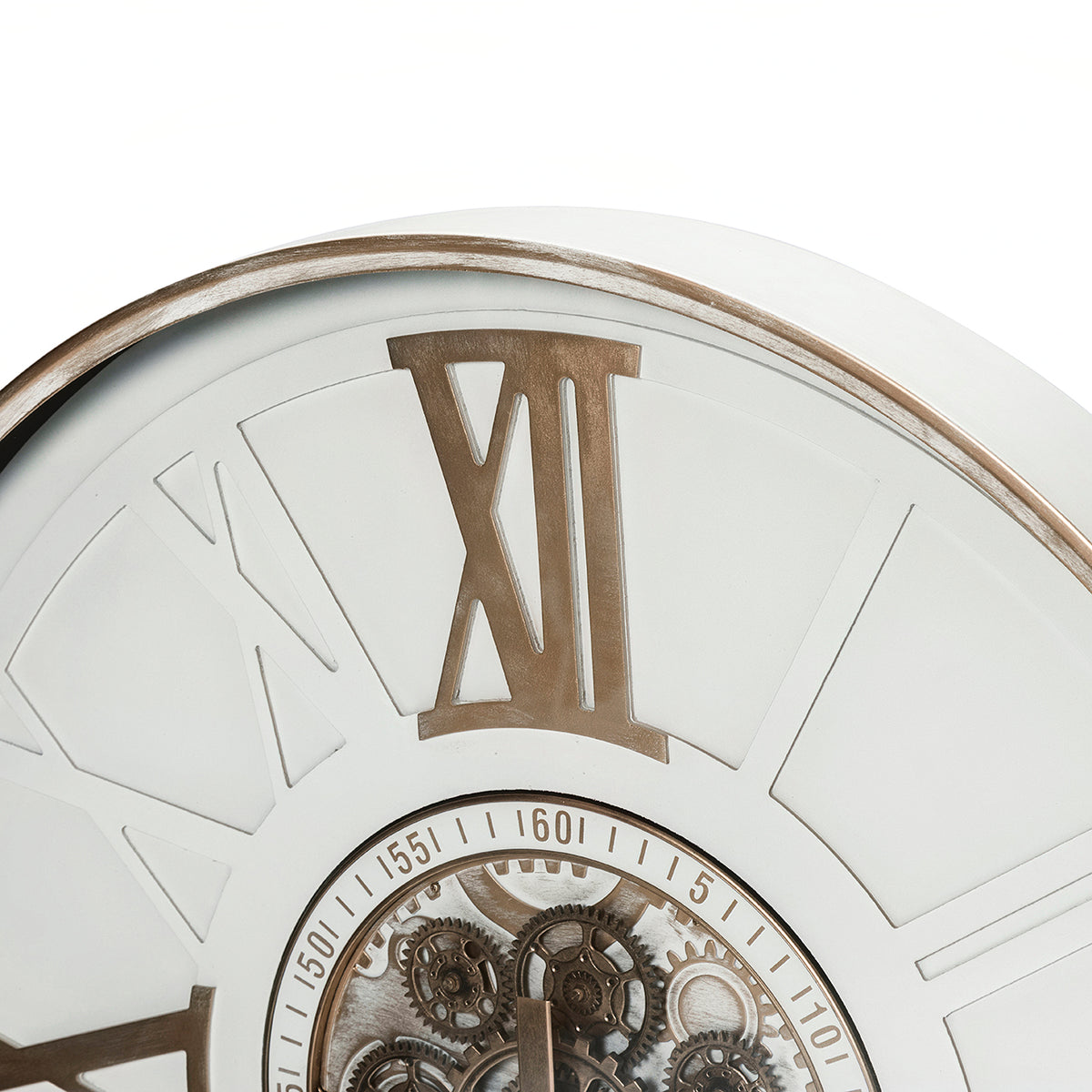 Close-up of the clock's gold-toned XII numeral, distressed rim and upper section of the numbered ring around the cogs.